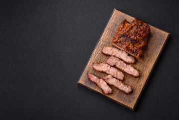 Fresh juicy delicious beef steak on a dark background