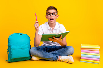 Full length photo of funky cool shool boy dressed polo t-shirt backpack pointing pen up enjoy education isolated yellow color background