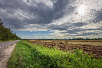 A road with a field on the side