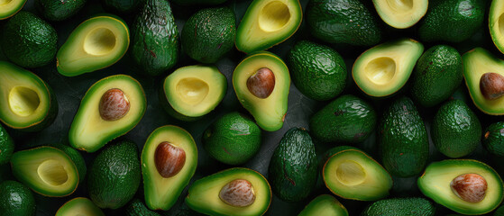 Close-up of numerous ripe avocados with and without pits.