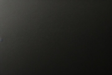 Black foil gradient texture background with uneven surface