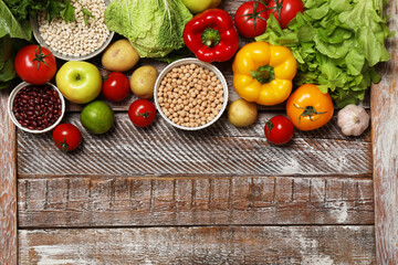 Different vegetarian products on wooden table, top view. Space for text