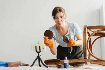Carpenter woman recording diy video blog about furniture restoration