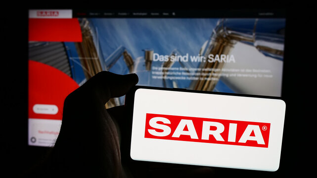 Stuttgart, Germany - 08-06-2024: Person holding mobile phone with logo of German food service company Saria AS GmbH Co. KG in front of business web page. Focus on phone display.