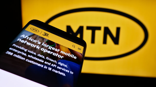 Stuttgart, Germany - 08-07-2024: Mobile phone with website of South African telecommunications company MTN Group Limited in front of logo. Focus on top-left of phone display.