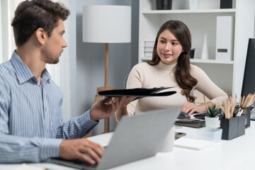 Smiling beautiful woman hand over folder report analysis paper to smart manager on desk at side...