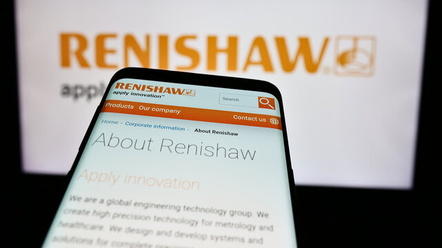 Stuttgart, Germany - 08-08-2024: Smartphone with website of British engineering company Renishaw plc in front of business logo. Focus on top-left of phone display.