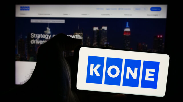 Stuttgart, Germany - 08-08-2024: Person holding smartphone with logo of Finnish elevator engineering company Kone Oyj in front of website. Focus on phone display.