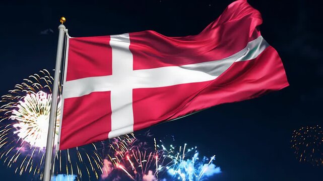 Colorful fireworks illuminate the night sky, featuring a prominent Denmark flag as a symbol of celebration and unity