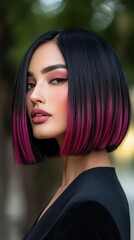 Stylish woman with a sleek black bob haircut and vibrant pink ombre, showcasing bold makeup in an outdoor setting.