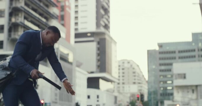 Businessman spilling coffee, dropping phone and paperwork while rushing, walking and talking on a call in the city. Troubled, embarrassed, and busy young guy accidentally badly tripping in the street