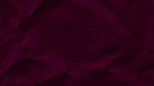 Stop motion animation of crimson red wrinkled paper texture, showcasing creases and subtle imperfections for design use. 4K Motion Graphics.