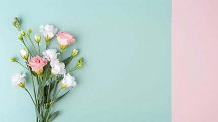 Fototapeta premium Mixed eustoma lisianthus flowers on pastel pink and green background with ample copy space. Flat lay floral composition, ideal for greeting cards, invitations, banners, posters, and wedding-themed