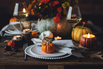 Elegant atmospheric beautiful dinner table setting for thanksgiving or wedding celebration, fall...