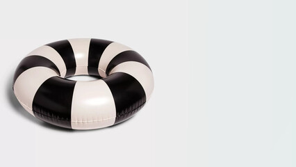 Closeup of inflatableblack and white swim tube on copy-space background.