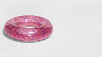 Closeup of inflatable glitter swim tube on copy-space background.