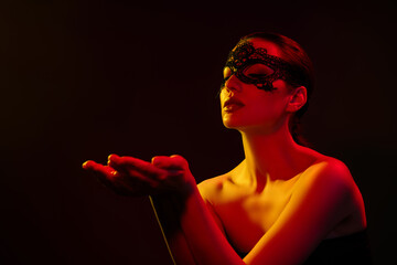 Photo of passionate shiny model naked shoulders lace mask arms empty space isolated black red neon...
