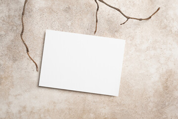 Blank invitation, flyer or greeting card mockup on beige background, copy space, top view