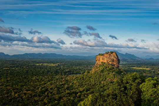 Sigiriya or Sinhagiri Lion Rock ancient rock fortress near Dambulla in Sri Lanka, historical and archaeological significance dominated by a massive column of granite, landscape view.