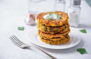 Corn fritters wih cream sauce in a plate