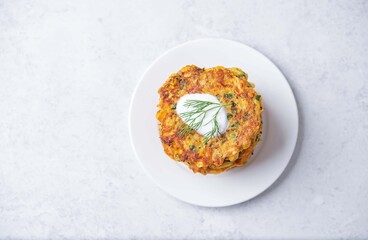 Corn fritters wih cream sauce in a plate