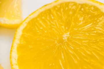 Lemon slice in macro photography on a white background. Fresh and juicy lemon, clipart. High resolution photo of citrus fruits and sliced lemon