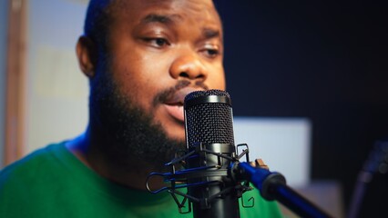 Skilled composer producing a new melody with lyrics and piano keys, recording audio files to edit...