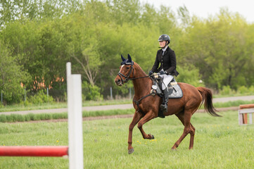 Young woman preparing for equestrian competition. 