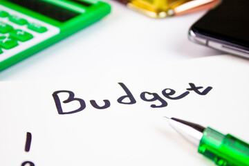 BUDGET is a word written in marker on a pad of paper with a calculator and a pen and a notebook. Budgeting, financial and economic plan, budget planning, financial concept.