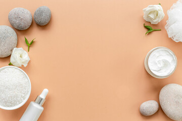 White cosmetics products with stones and white roses