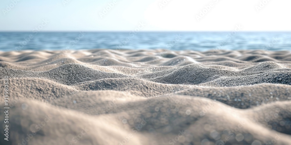 Poster a close-up view of sandy texture on a beach, with the vast ocean in the background