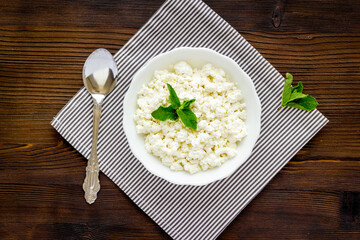 Farm cottage cheese in white bowl, top view. Healthy protein breakfast