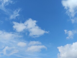 White clouds and blue sky. The view of the clouds and sky is clear and calming
