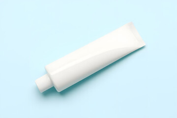 White cosmetic tube pack, isolated on pastel blue background.
