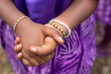 Traditional wrist beads worn by a Devotee and worshippers of the Osun goddess praying at the river during the annual Osun Osogbo Festival held in Osun State, Nigeria - West of Africa, August 9 2024