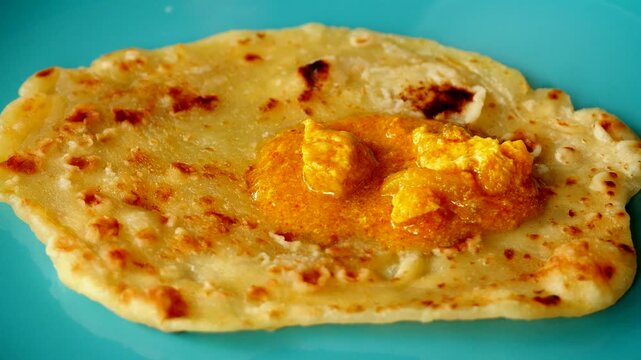 Topping curry on naan bread, in door  Chiangmai  Thailand.