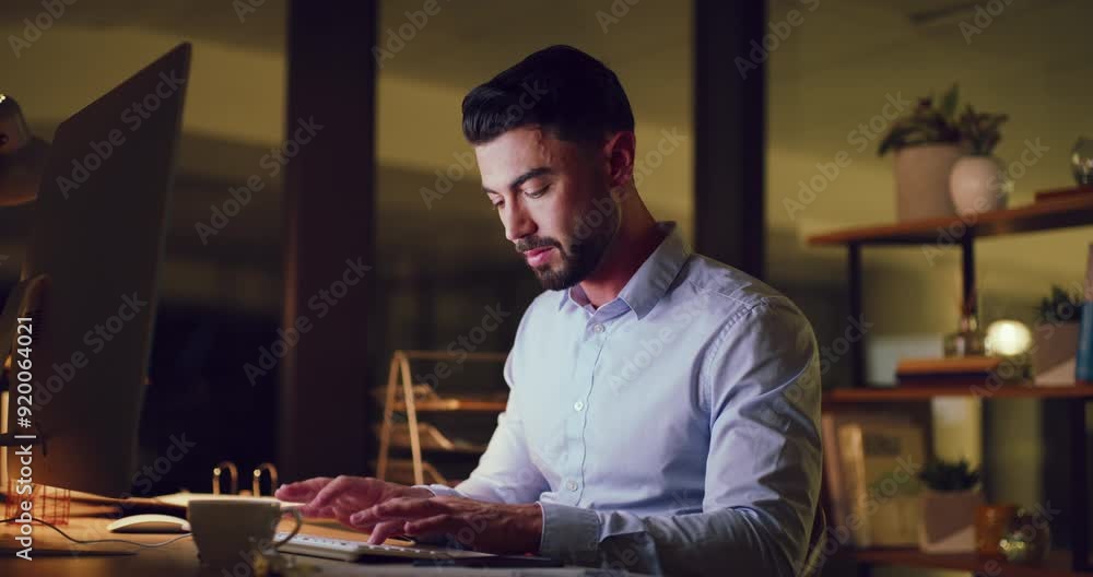 Poster Businessman typing on computer while working late in an office at night. Hardworking entrepreneur sending emails, doing online research and writing reports trying to reach deadline during overtime