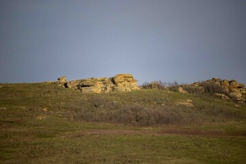 Obraz premium A Strong Rock formation sitting on Hill