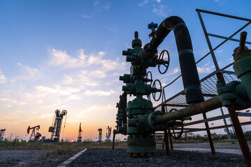 In the evening, oil pumps are running, Silhouette of beam pumping unit