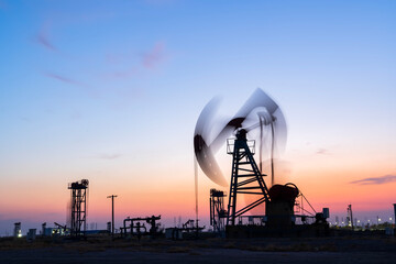 In the evening, oil pumps are running, Silhouette of beam pumping unit