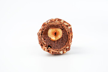 Sweet chocolate balls is made. Chocolate candy in gold wrapper on white background