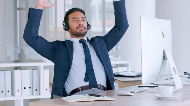 Confident male call centre agent talking on headset and looking relaxed while working in an office. Successful and funny salesman consulting and operating a helpdesk for customer service and support