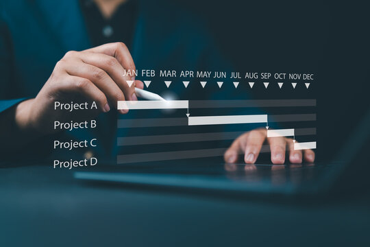 Scheduling and proceeding with task reports, updating or tracking engineering progress. Project engineer or manager uses laptop to manage construction or operation plans with Gantt chart schedules.