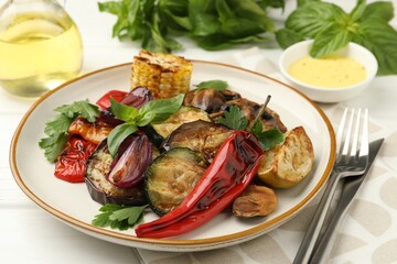 Delicious grilled vegetables with spices served on white table, closeup