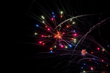 Fireworks on the dark sky background. Colorful fireworks from Loto Quebec in Quebec, Canada. Abstract colored firework background with free space for text. fireworks light up the night sky