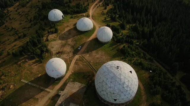 Pamir old military radar station. Aerial view of abandoned secret army site, former radio locating station, Carpathian mountains, Ukraine. Futuristic architecture buildings in forest.