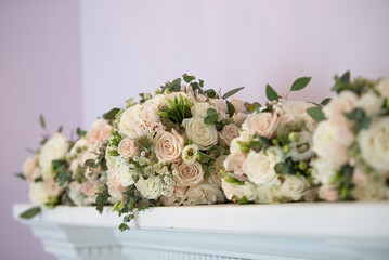Pink pastel and white roses bridal bouquets lined up on fire place mantle