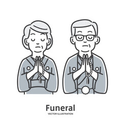 葬儀で手を合わせる年配の夫婦