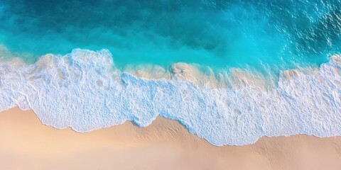 Obraz premium An aerial view captures the gentle embrace between the azure waves and the soft sandy beach, creating a tranquil and picturesque scene.