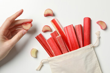 Ripe stalks of rhubarb on a light background